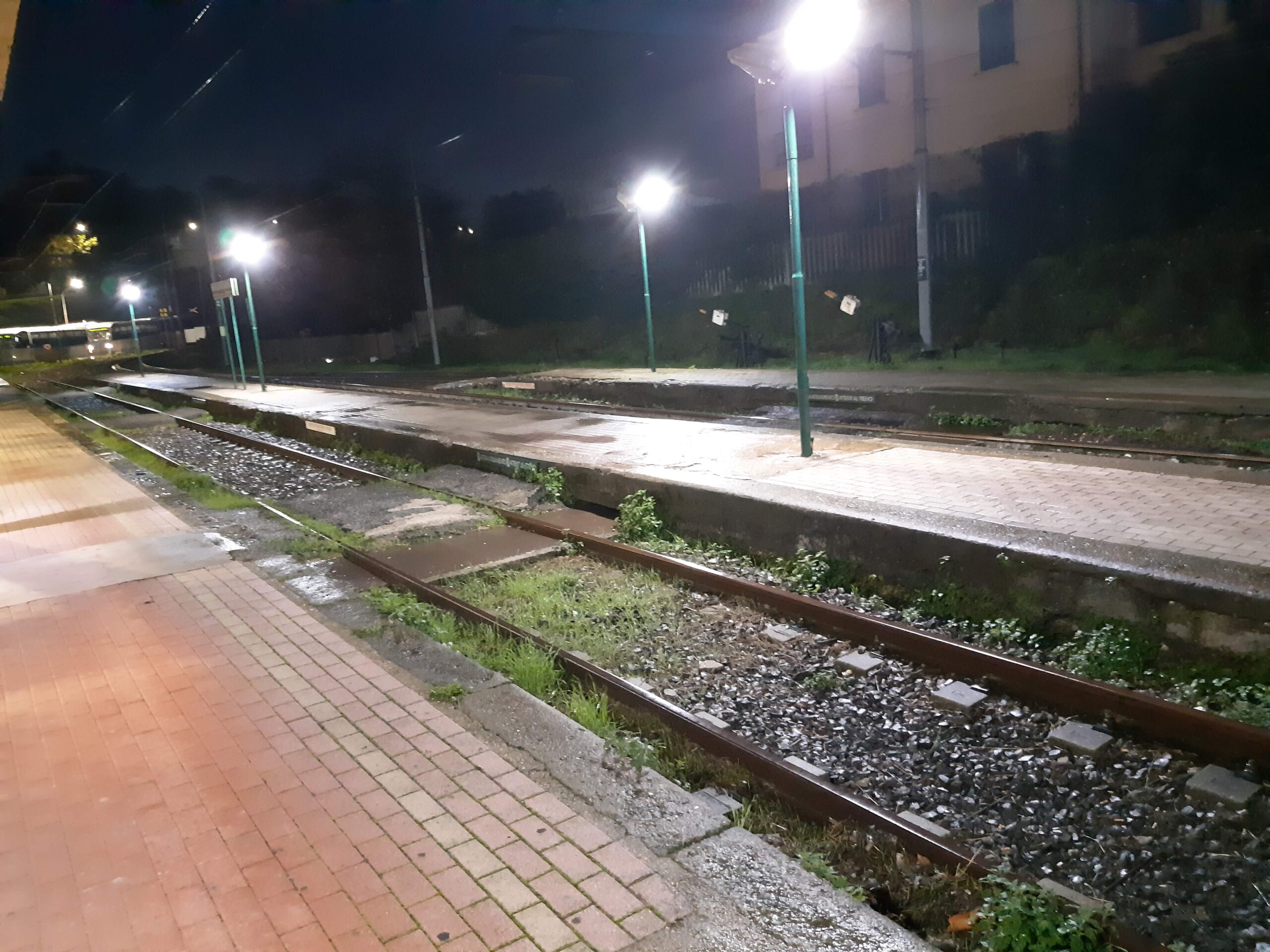 Immagine notturna di una piccola stazione ferroviaria illuminata dalla luce di alcuni lampioni. Il male morale (aischron) è su un percorso cupo e solitario le cui apparenze sembrano, però, condurre verso una meta. Le parole della filosofia rock stoica sono strumenti del lavoro per la cura di sé.
