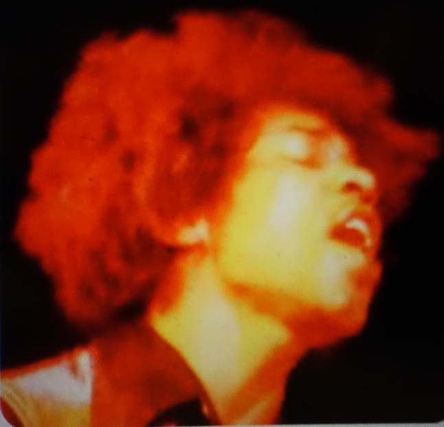 Foto in primo piano di Jimi Hendrix virata in giallo e rosso (opera di Karl Ferris) per la copertina americana dell'album "Electric Ladyland" della The Jimi Hendrix Experience.